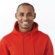Close-up portrait of healthy good-looking african-american man in red hoodie, staying optimistic, having faith all be good, smiling pleased and enthusiastic, standing white background joyful.